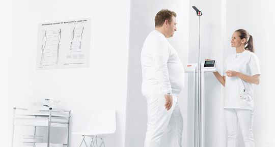 Nurse measuring patients weight and height with the Seca 777
