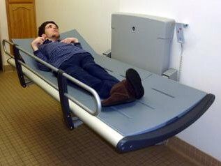 Pediatric Pressalit Care 3000 Special Needs Changing Table with Safety Rails in use.