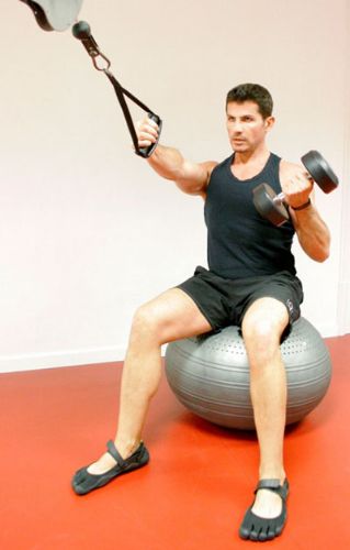 Man exercising while sitting on the Togu Inflatable Exercise Powerball 