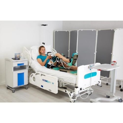 Spectra Essential Knee CPM Machine (Shown with Optional Green Foam Pad Kit with Black Straps) In Use