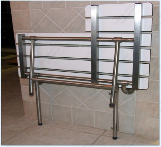 Shower Transfer Bench Folded Against a Wall