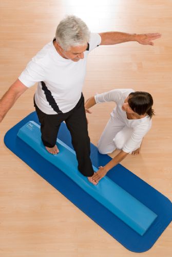 Therapist assisting patient on the Airex Balance Beam
