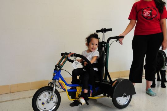 The Discovery Series DCP Mini Pediatric Tricycle can be driven by the rider as well as guided from behind
