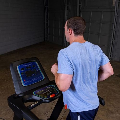 Folding treadmill showing its controls while jogging