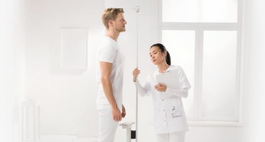 A Nurse and Sportsman Using the  Seca 769 Digital Scale with Stadiometer and BMI Function