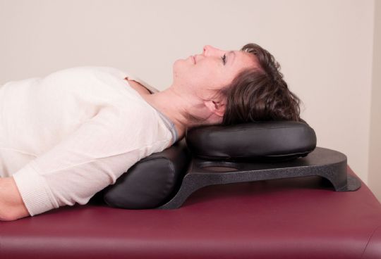 User lying supine using the Oakworks MRI Safe Prone Pillow Face Rest 