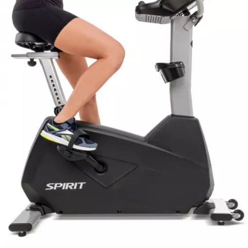 Spirit Fitness CU800 Upright Bike shown how to properly place one's foot inside pedal protector