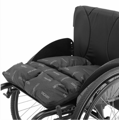 The Vicair Adjuster O2 (Standard or Low) Wheelchair Cushion by Permobil showing it's comfortable fit on a wheelchair.