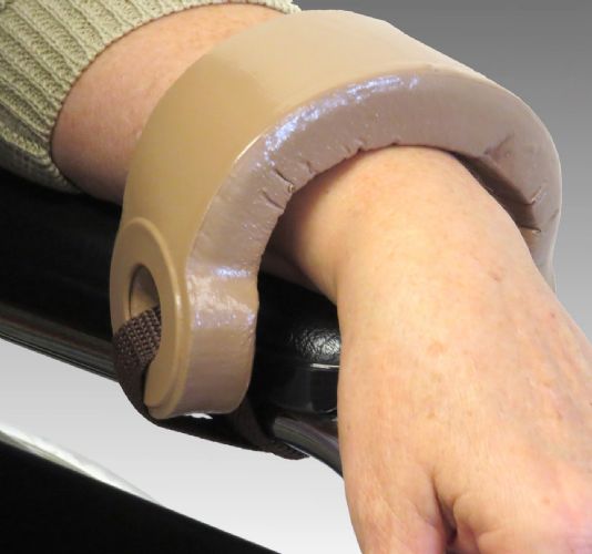 Close up view of the product in use securing wheelchair user's hand