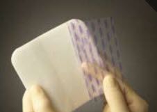 Mepilex Foam Dressing has an adhesive backing that sticks to skin but not wounds