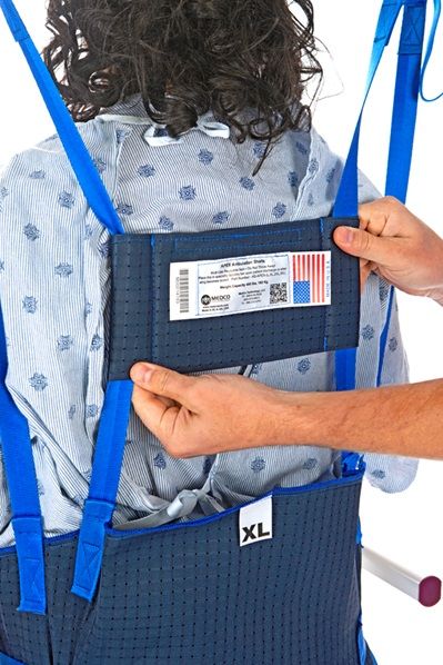 The strap and webbing control pocket also functions as a tension and support mechanism for the patient's chest and back. 