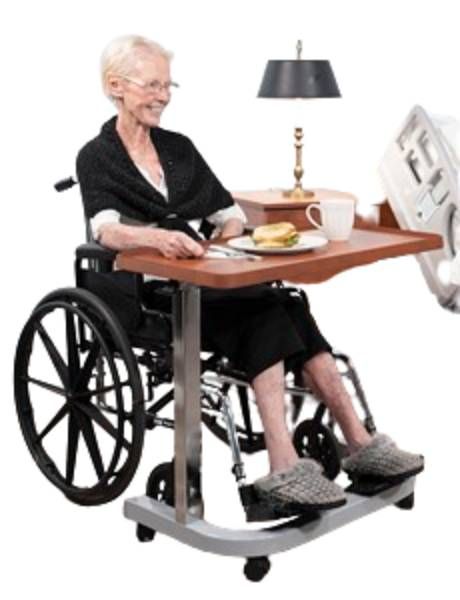 Picture shows the overbed table in use over a wheelchair provided the wide u-shaped base allows for it