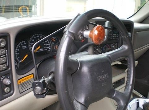 The adapter is shown above. It is the long black lever behind the steering wheel. It attaches to the turn signal arm (left), crosses over the steering wheel column, and the lever sits at the top right side behind the steering wheel. (It is not the brown knob.)