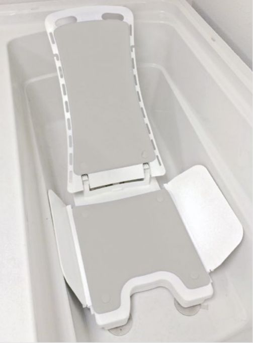 Marlin Pediatric Bath Lift with Reclining Back lowered into a tub.