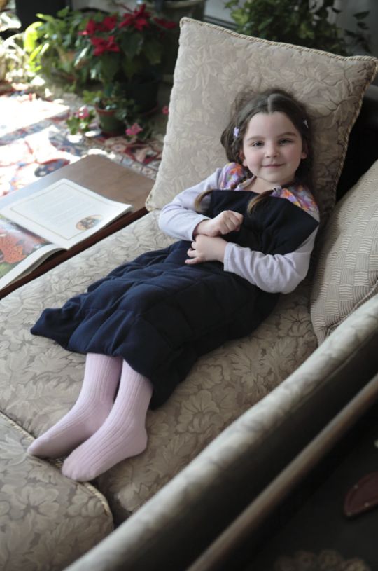 Child using a Navy Flannel Weighted Washable Body Blanket
