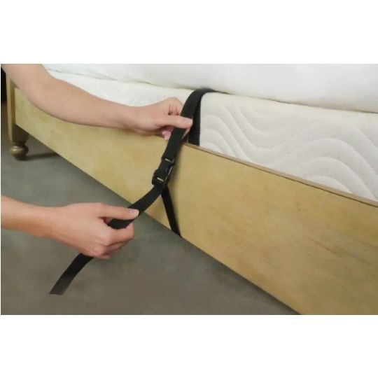 Strap attaches to bed frame for maximum security