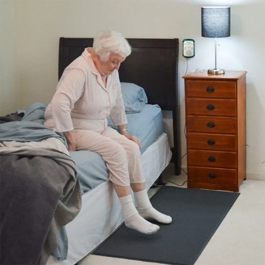 The caregiver receives an alert with the use of a pager when someone is getting up from a bed, or a chair, or approaching an exit
