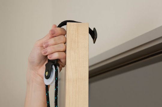Webbing anchor fits snugly between the door and frame