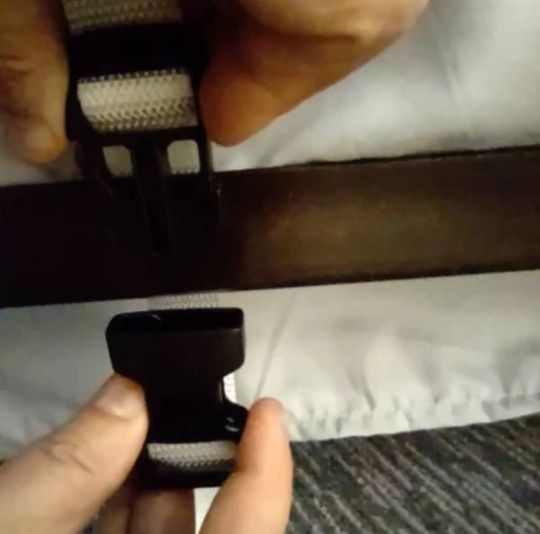 Picture shows how the rail will be buckled/strapped to the bed frame for security 