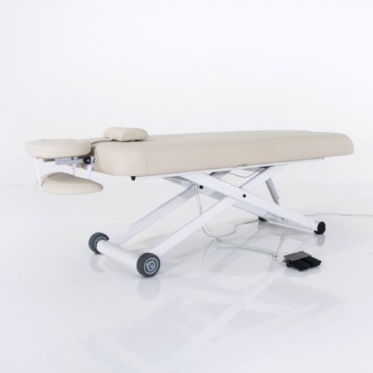 Light beige silverfox massage table featuring an adjustable headrest, height control, and wheels