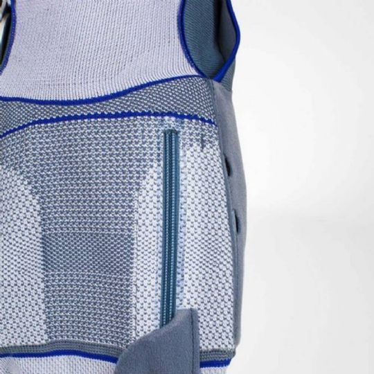 Side view of softec genu knee brace showing convenient calf zipper for easy wear