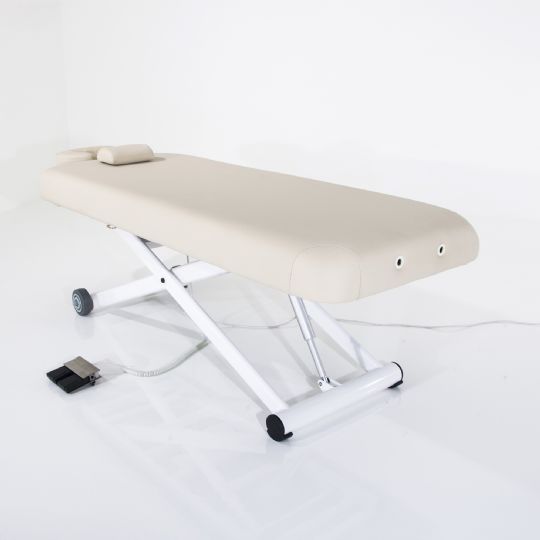 Light beige silverfox massage table with motorized height adjustment and foot control