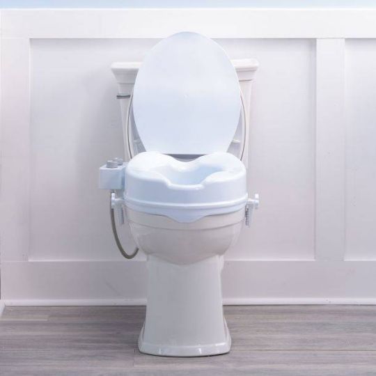 Front view of raised toilet seat with bidet, providing elevated seating and adjustable water controls for added hygiene and comfort