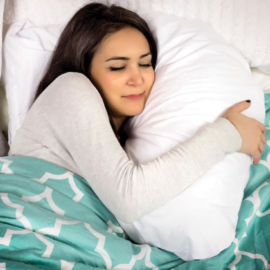 Comfortably hugging the dmi hugg-a-pillow for a restful night￿s sleep