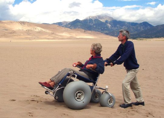 This wheelchair easily rolls across sand, even in the desert