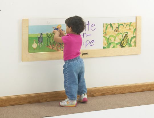 A toddler explores pictures displayed in an easy-to-clean acrylic framer