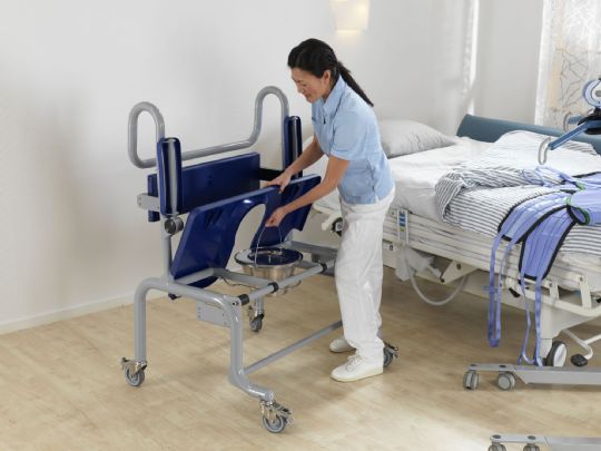 Seat folds up to allow caregivers access to the optional bedpan (Showing Carmina without Footrest)