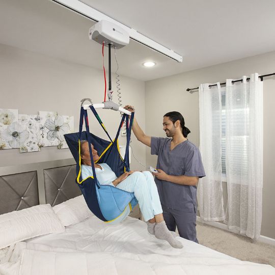 Shown with Bull Horn carry bar attached to the ceiling lift, and a sling <i>(carry bar and sling sold separately)</i>