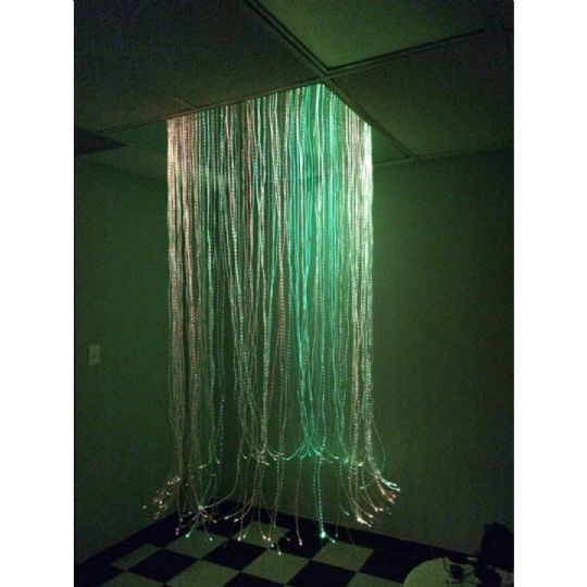 LED fiber optic strands cascade in a full circle from ceiling to floor.