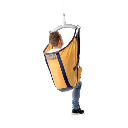 Person seated in a guldmann amputee sling, designed for secure lifting and full-body support