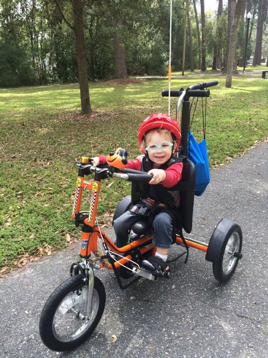 Discovery Series DCP Mini Pediatric Tricycle in Metallic Orange, Picture shows the tricycle in use
