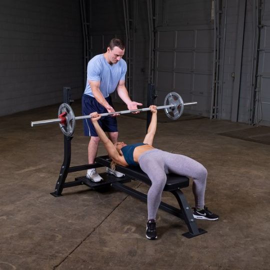 Executing bench press (barbell and weights not included)