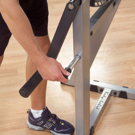 Pull pin to lower arm, grab v-bar handle, adjust arm for triceps workout.
