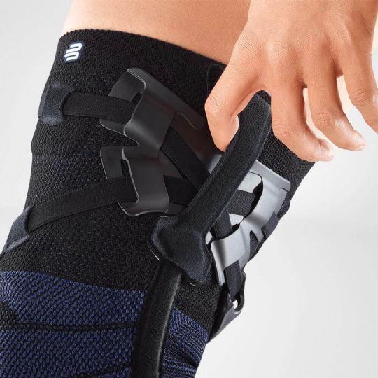 Close-up of the genutrain oa knee brace showcasing easy-to-use finger loops for quick and secure adjustments