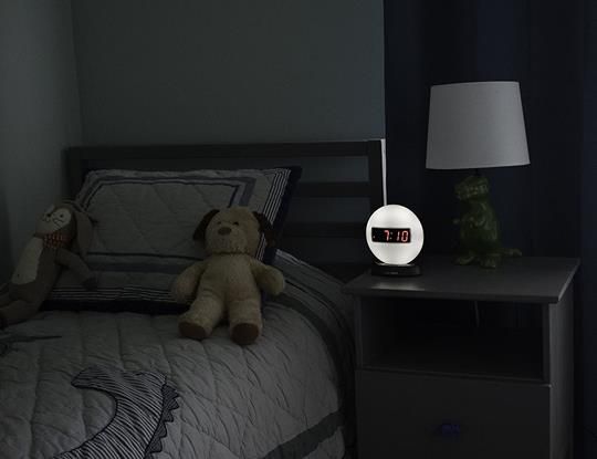 Sonic Glow Alarm Clock softly illuminating a cozy bedroom setting