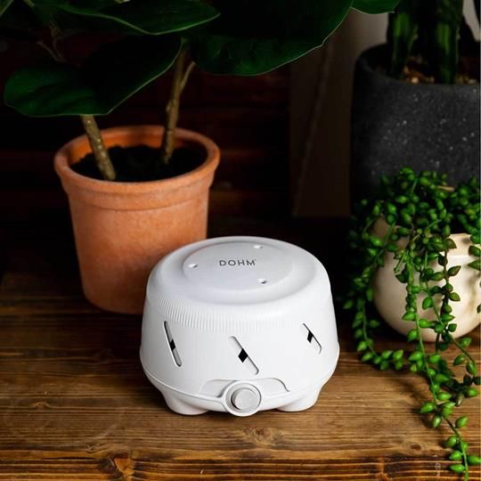 Yogasleep Dohm Uno White Noise Machine blending seamlessly into a natural setting