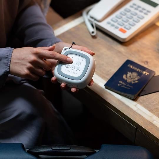 Adjusting the settings on the Yogasleep Travelcube white noise machine for a customized sleep experience