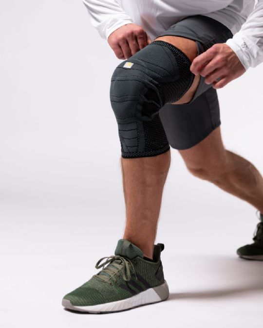 Compressive Material fully encompasses knee joint and patella