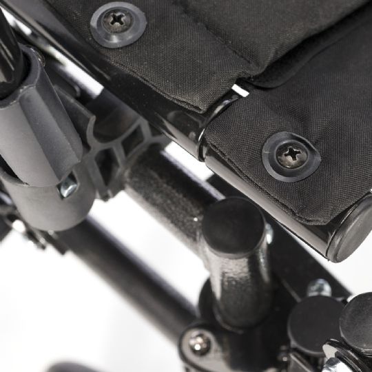 Close-up of wheelchair frame and upholstery connection for durability.