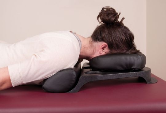 User lying prone using the Oakworks MRI Safe Prone Pillow Face Rest 