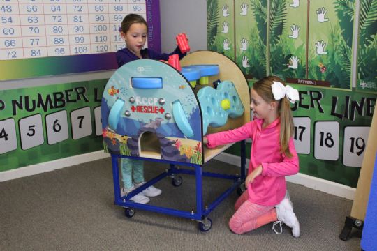 Kids exploring motor skills and problem-solving with the Reef Rescue tool in a fun classroom setting