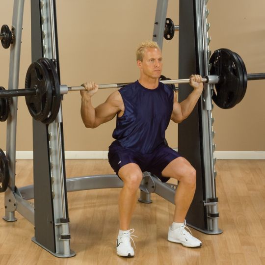 Weighted bar squats with the Pro Clubline Counter-Balanced Smith Machine
