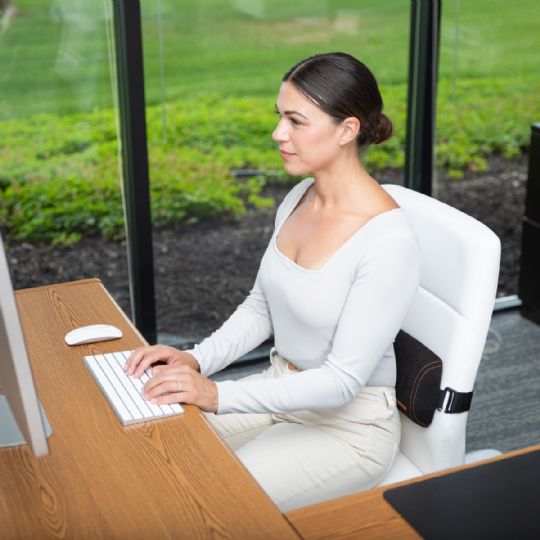 Working comfortably at a desk with the original mckenzie signature slimline for back support