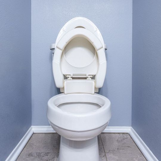 Raised toilet seat with hinged design for easy access and cleaning