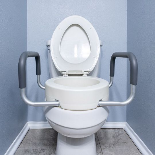 Raised toilet seat with supportive padded arms for extra stability