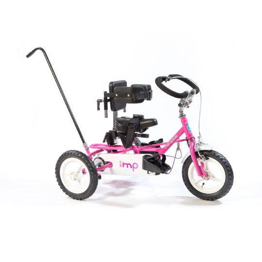Shown with In Line Trunk Support, Pelvic Strap, Leg Calipers and Foot Sandals, Multi-Axle Head Support, CumfiGrip Handlebar, Puncture Proof Tires, and Control Pole, in the Color Candy Pink